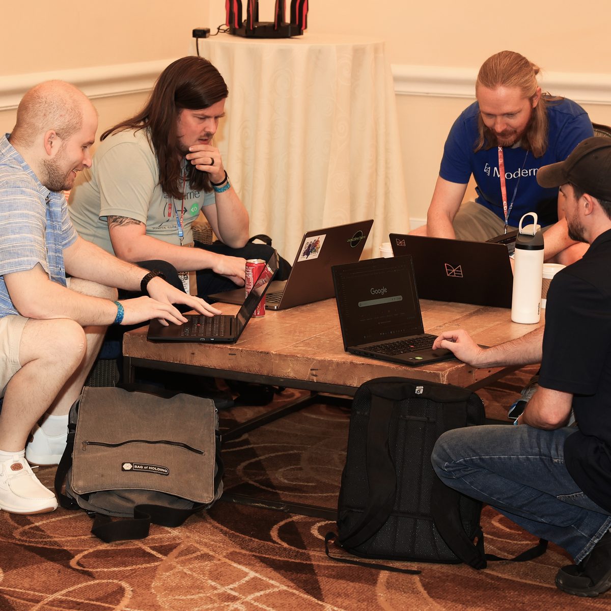 A Hack Track group working through a problem together over laptops